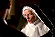 the nun brushes her rosary near Angel's hand