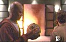 Wes hands Gunn the Buddha head